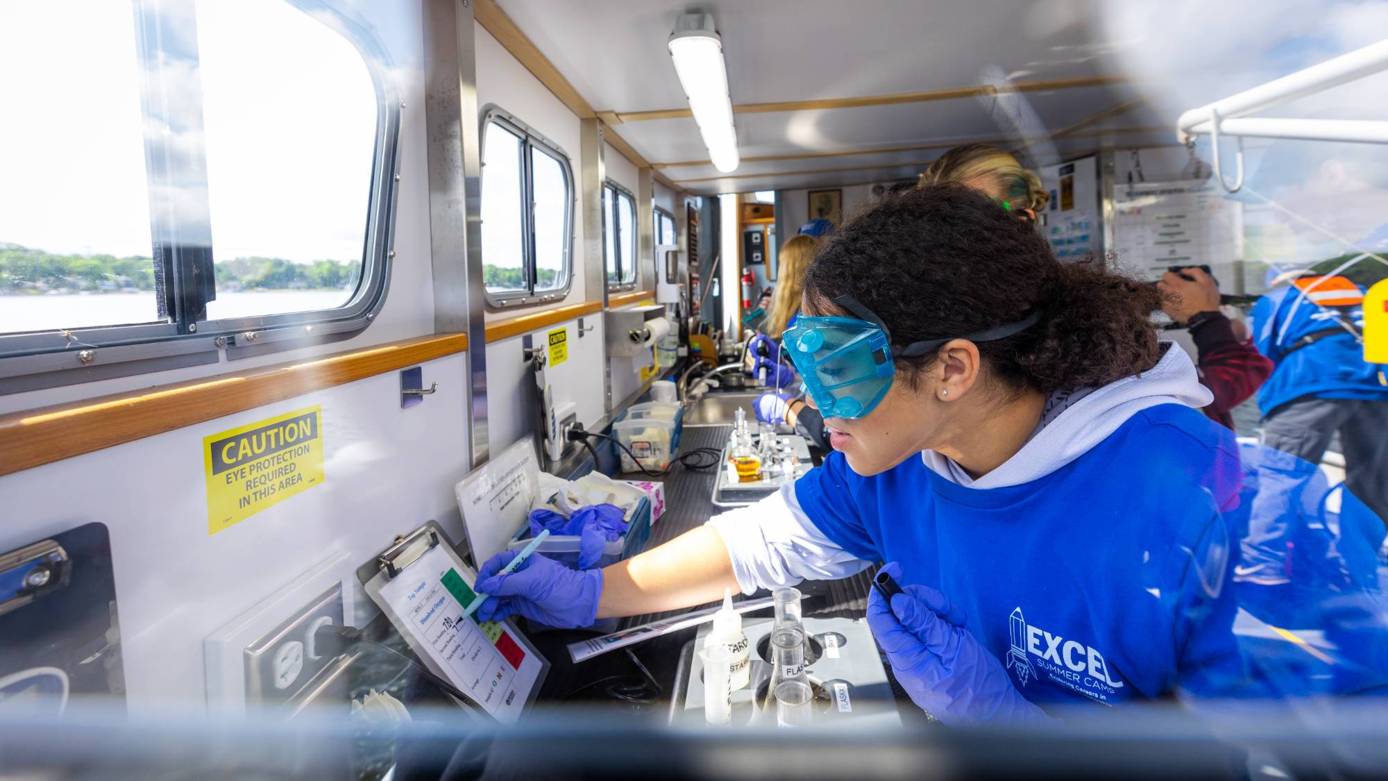 Visiting students measure water quality in the D.J. Angus's research laboratory.